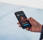 Un móvil con un símbolo de alarma, que simboliza los servicios de detección de Cyberzaintza.